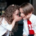 children sharing a secret