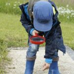 child using a magnifying glass