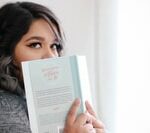 person looking over her book