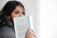 person looking over her book