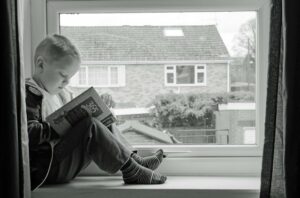 boy reading in the window box