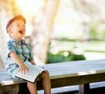 boy laughing at what he read