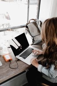 person writing on a laptop