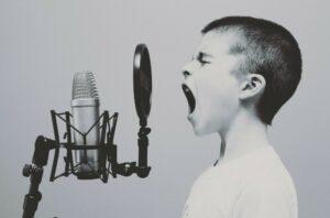 boy talking into a microphone